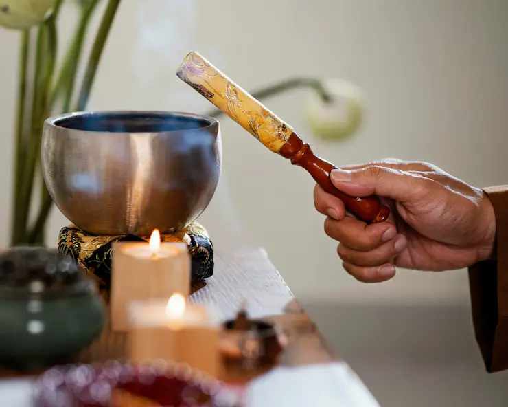man-holding-object-prayer-with-candles
